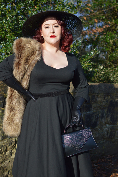 Plus size pinup Miss Amy May models the black Scarlette dress by Dolly & Dotty for a fit and sizing review