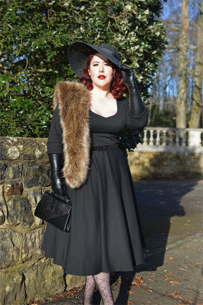 Plus size pinup Miss Amy May models the black Scarlette dress by Dolly & Dotty for a fit and sizing review