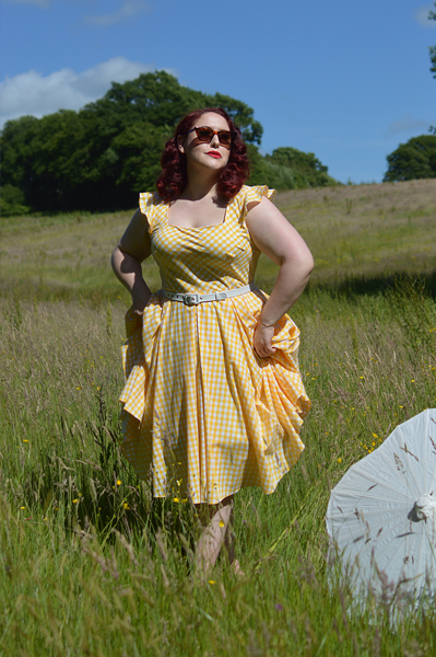 Plus size pinup Miss Amy May models the Elsie yellow gingham swing dress by The Pretty Dress company for a fit and size review