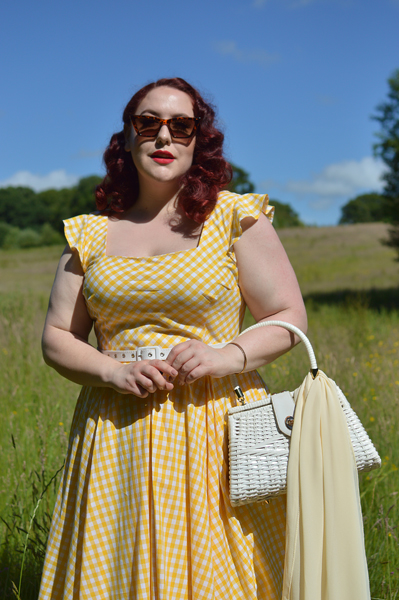 Plus size pinup Miss Amy May models the Elsie yellow gingham swing dress by The Pretty Dress company for a fit and size review