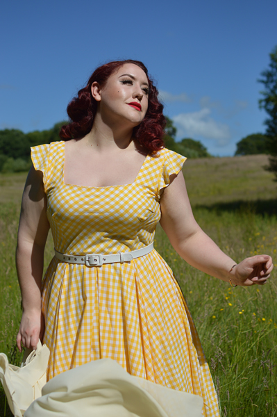 Plus size pinup Miss Amy May models the Elsie yellow gingham swing dress by The Pretty Dress company for a fit and size review