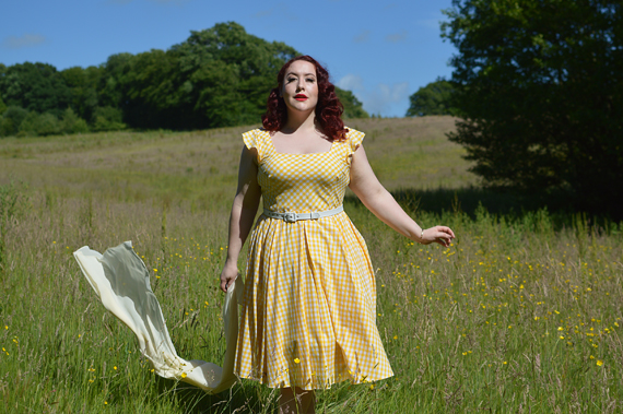 Plus size pinup Miss Amy May models the Elsie yellow gingham swing dress by The Pretty Dress company for a fit and size review