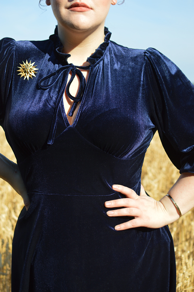 Plus size pinup Miss Amy May models the Orion navy velvet dress by Hell Bunny for a fit and size review