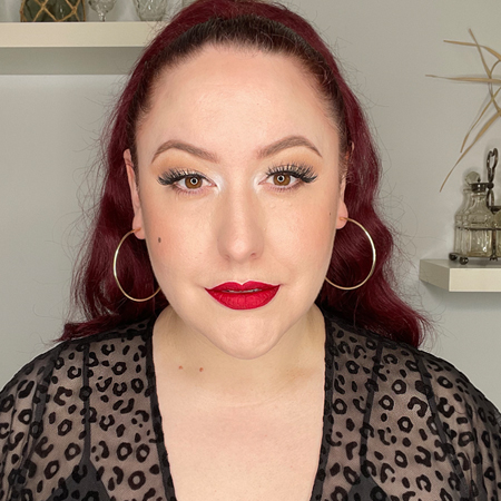 Beauty Bakerie's Matte Lip Whip in Cranberry Stiletto shown on pinup Miss Amy May in LED ring lighting