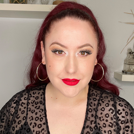 Beauty Bakerie's Matte Lip Whip in Mon Cheri shown on pinup Miss Amy May in LED ring lighting