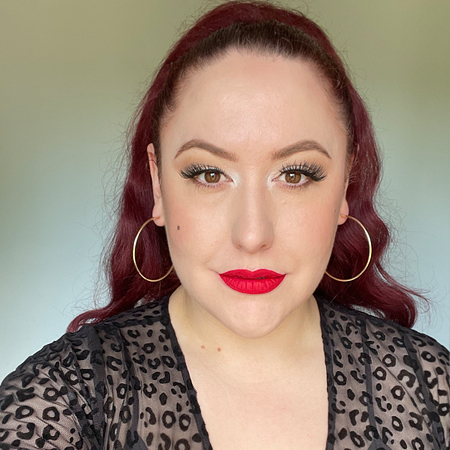 Beauty Bakerie's Matte Lip Whip in Mon Cheri shown on pinup Miss Amy May in in-direct natural lighting